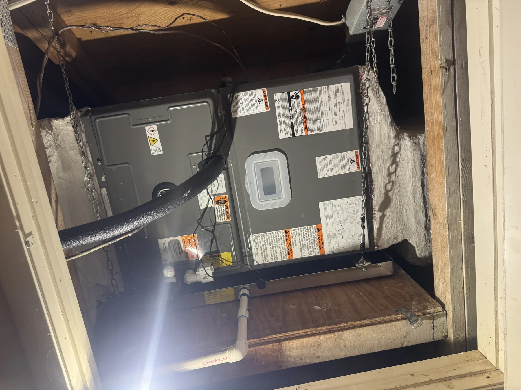 Attic HVAC installation work shown in a job photo