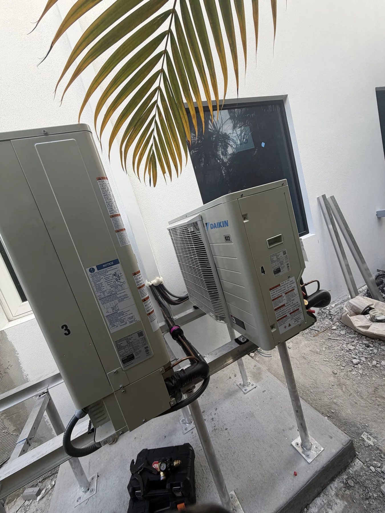 Photo of multiple air-conditioning condensers during installation work