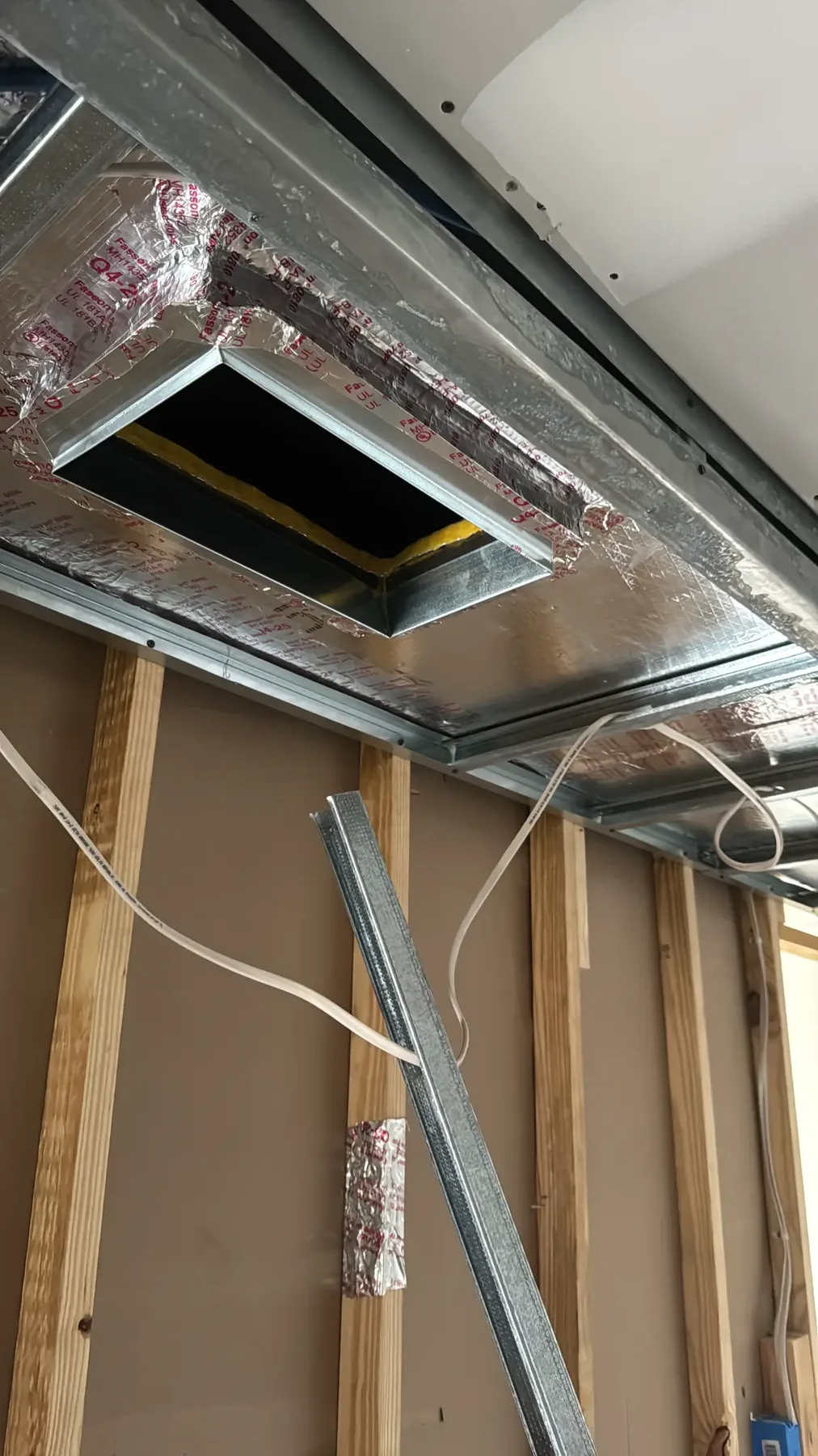 Custom sheet-metal duct boots and ceiling opening at an HVAC project